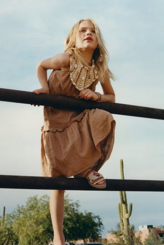 woman leaning on fence