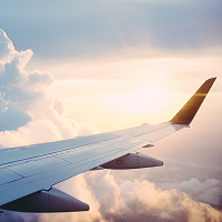 airplane wing over clouds