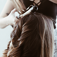 person curling other persons hair